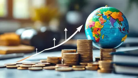 Globe on desk with stacked coins arrows pointing from europe middle east financial growth global expansion